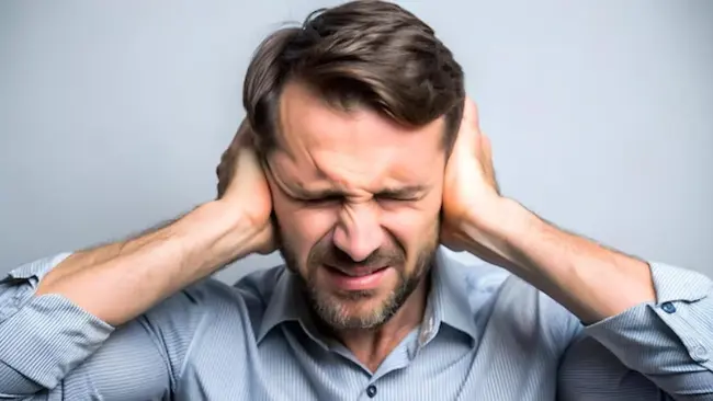 Man covering his ears